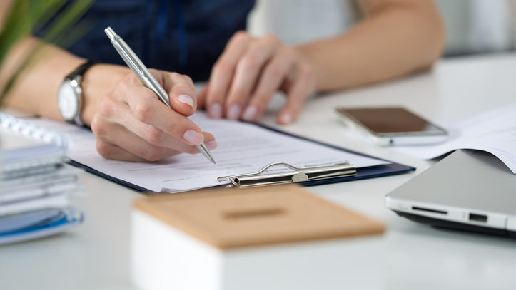 Woman writing something  sitting at her office