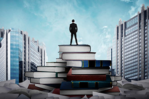 Businessman on Stack of Books
