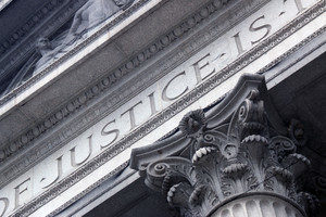 Courthouse close with Justice inscribed
