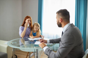 Mother and child talking with lawyer regarding wrongful death benefits.
