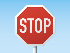 The word stop written against red background on octagon shaped sign