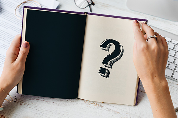 book showing a page with a large question mark on the page