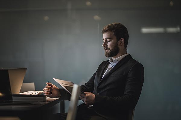person sitting in chair looking at document