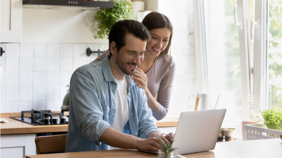 couple using laptop choosing a foreign trust company