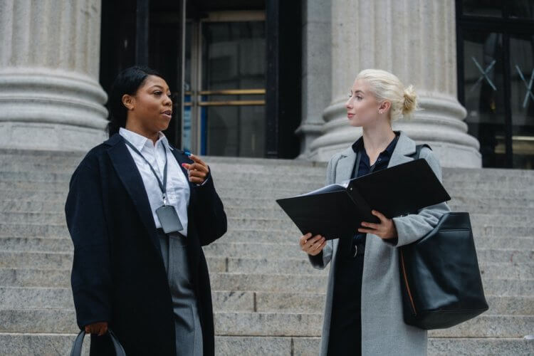 Lawyer prepping client at courthouse Lawyer prepping client at courthouse