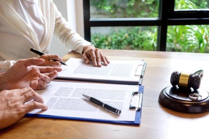couple reading over divorce papers in office