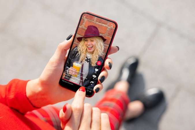 Woman viewing social media on her phone.