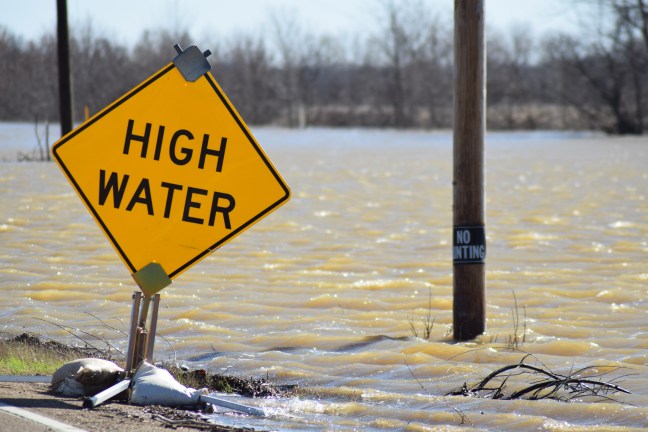 Mississippi flood water sweep across roadways.