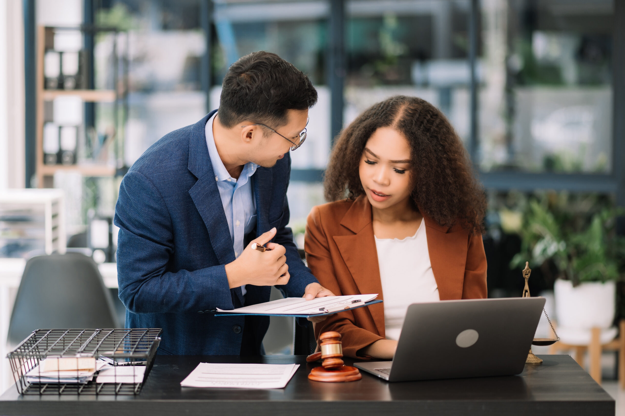 An employer going over a contract with a mediator to ensure that it complies with the upcoming laws SB 699 and AB 1076.