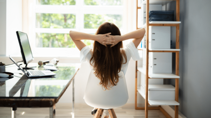 Woman reclining in a chair looking out a sunny window