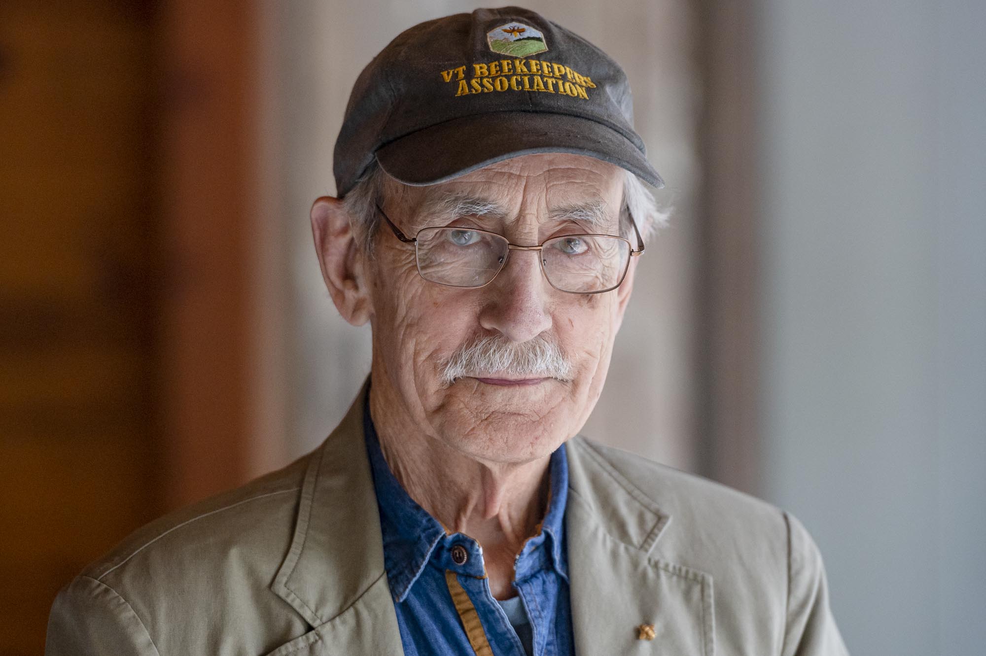 an older man wearing a hat and glasses.