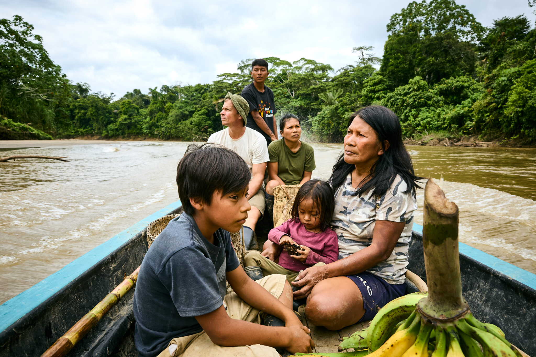 Waorani leader Nemonte Nenquimo with her family on a canoe trip down the Curaray River after harvesting food from their forest garden in the Ecuadorian Amazon.