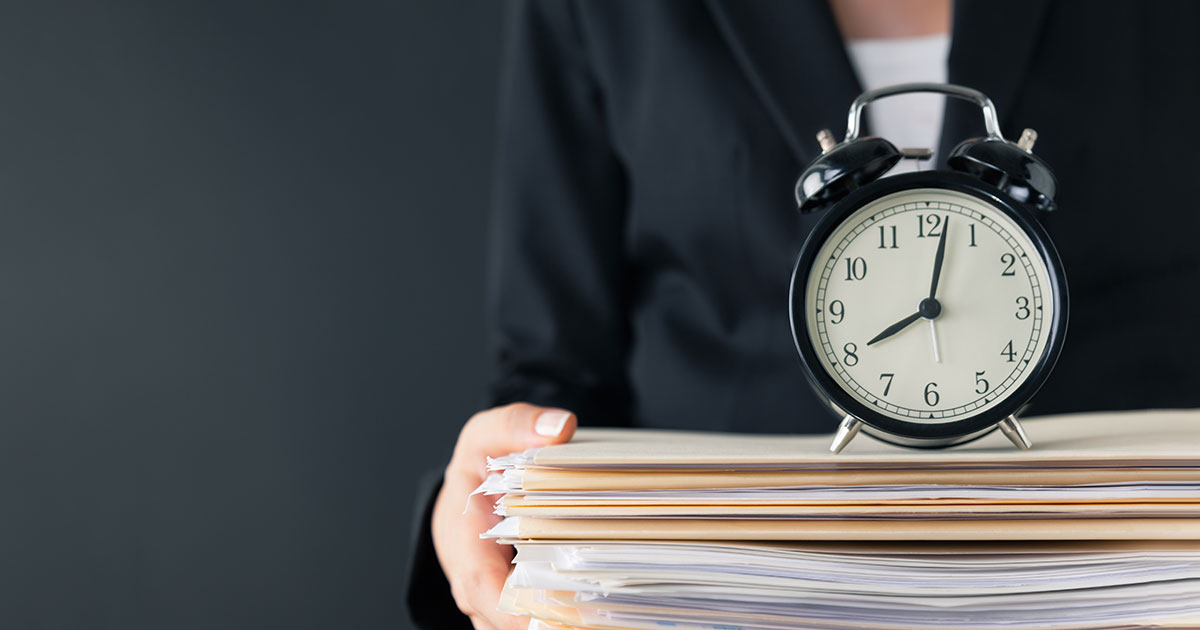 Stock Photo of a Clock on Court Files Held by Lawyer